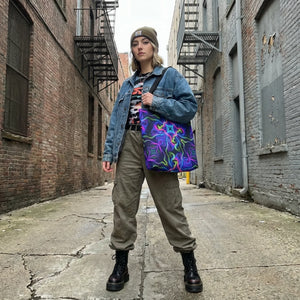 Woman in streetwear with neon psychedelic tote bag, denim jacket, and combat boots in urban alley