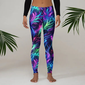 Front view of vibrant psychedelic leggings with neon floral design worn by model in minimalist setting with green leaves