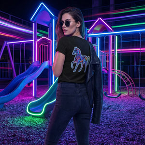 Woman wearing black psychedelic horse print t-shirt and sunglasses holding leather jacket in neon-lit playground