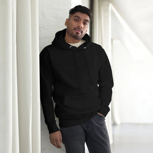 Man wearing black unisex premium pullover hoodie in bright modern interior for streetwear fashion