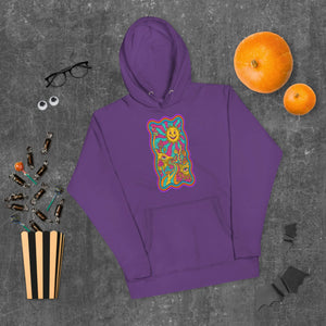 Purple unisex premium pullover hoodie with psychedelic sun and mushroom art, Halloween candy, pumpkins, and black glasses on gray background