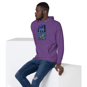Man wearing purple hoodie with colorful psychedelic abstract face design, sitting on white block, blue ripped jeans