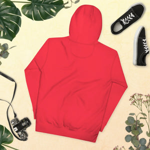 Back view of unisex red premium pullover hoodie on yellow background with black sneakers, vintage camera, and tropical leaves