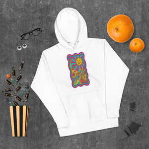White unisex hoodie with vibrant psychedelic sun and mushroom design, Halloween candy and pumpkins background