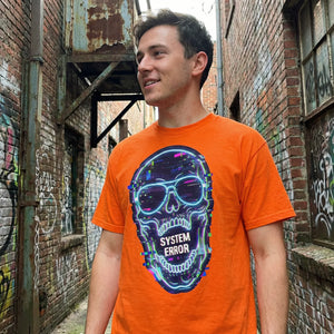 Man wearing orange psychedelic 'SYSTEM ERROR' skull t-shirt by Mad Lad Designs in graffiti alley