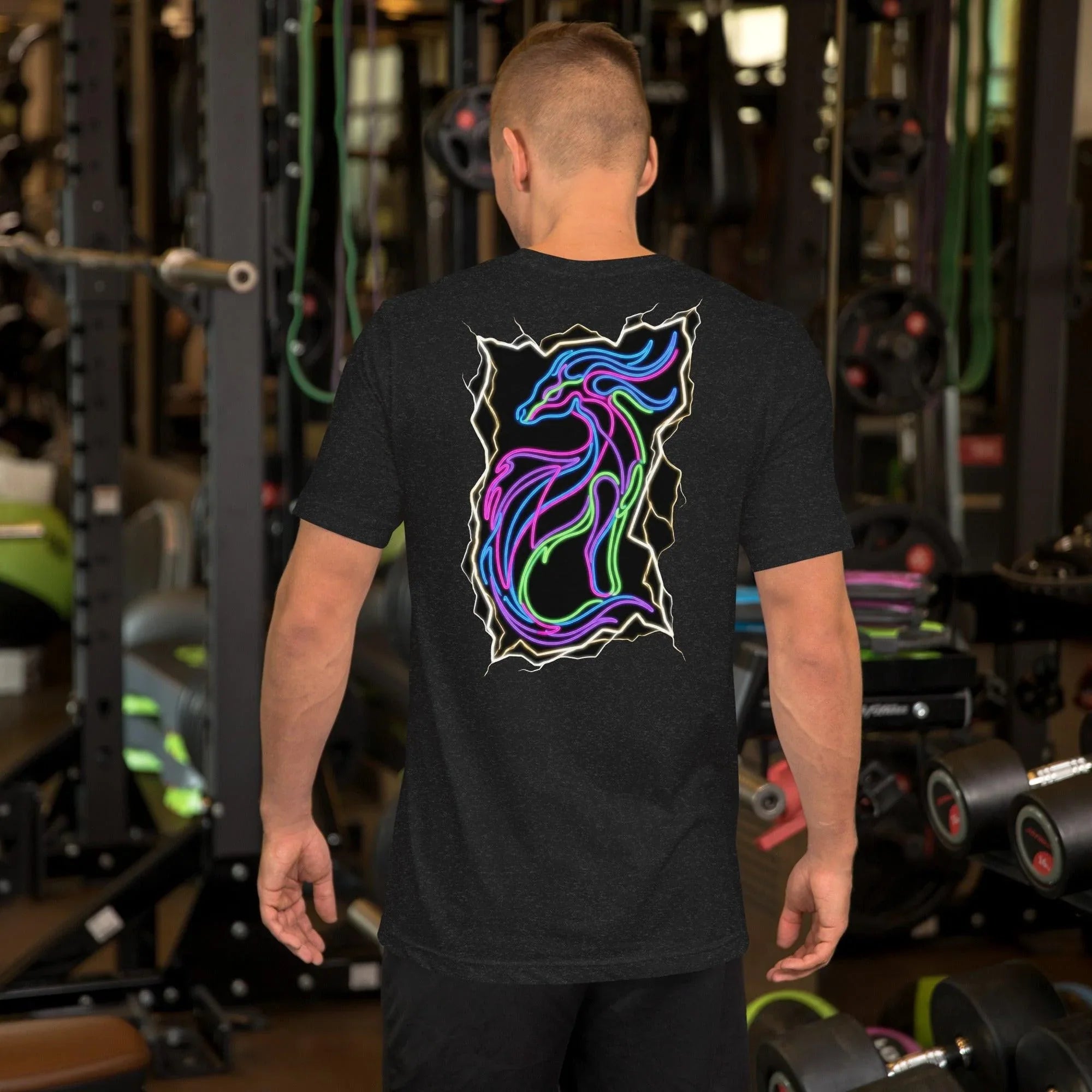 Man wearing black heather unisex t-shirt with neon psychedelic dragon design in gym setting