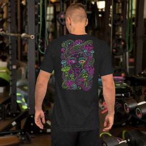 Man wearing black t-shirt with colorful psychedelic Medusa design at gym with weights