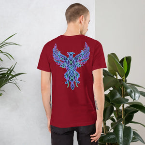 Man wearing cardinal red t-shirt with neon blue and green phoenix design on back in indoor setting with plants