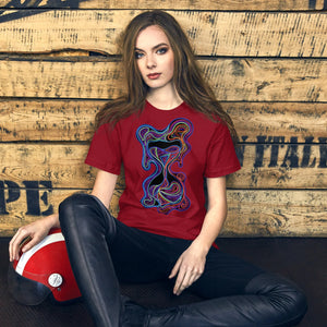 Young woman wearing cardinal red psychedelic graphic T-shirt, seated against rustic wooden wall with red vintage helmet
