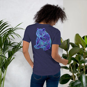 Person wearing midnight navy unisex t-shirt with neon psychedelic tiger design, surrounded by green plants
