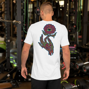 Man wearing white unisex t-shirt with psychedelic hand and eye flower graphic, gym background