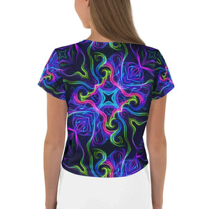 Back view of woman wearing all-over print crop tee with vibrant psychedelic neon swirl and star patterns
