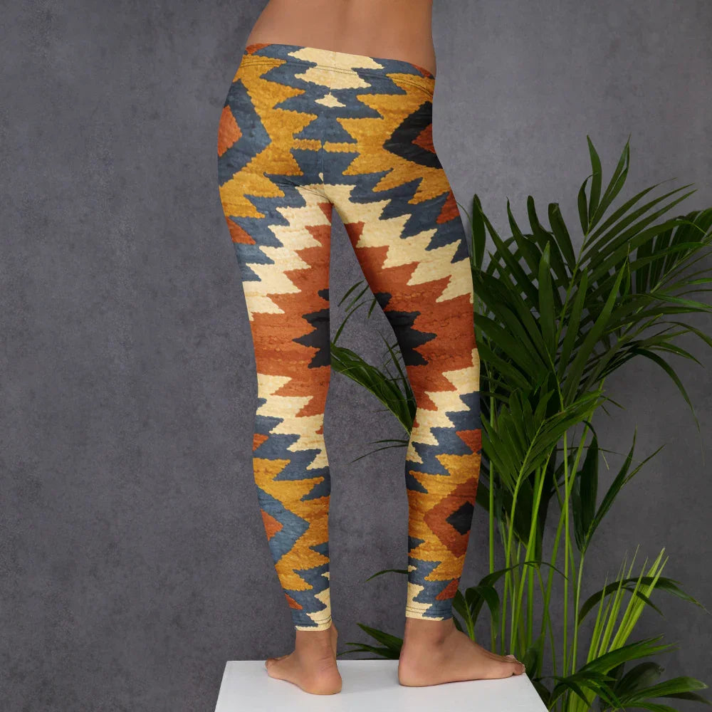 Colorful geometric patterned leggings by Mad Lad Designs, shown from the back, worn indoors.