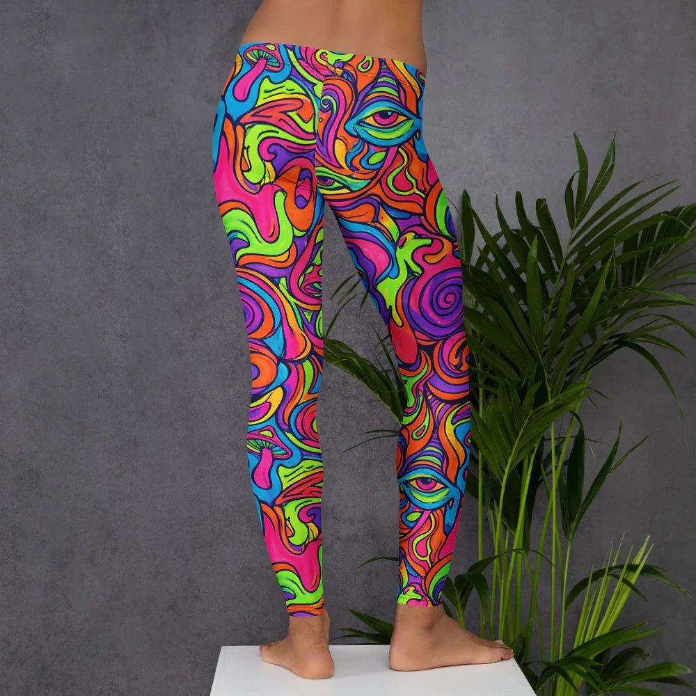 Model wearing vibrant psychedelic leggings with colorful abstract faces and swirls against a gray background