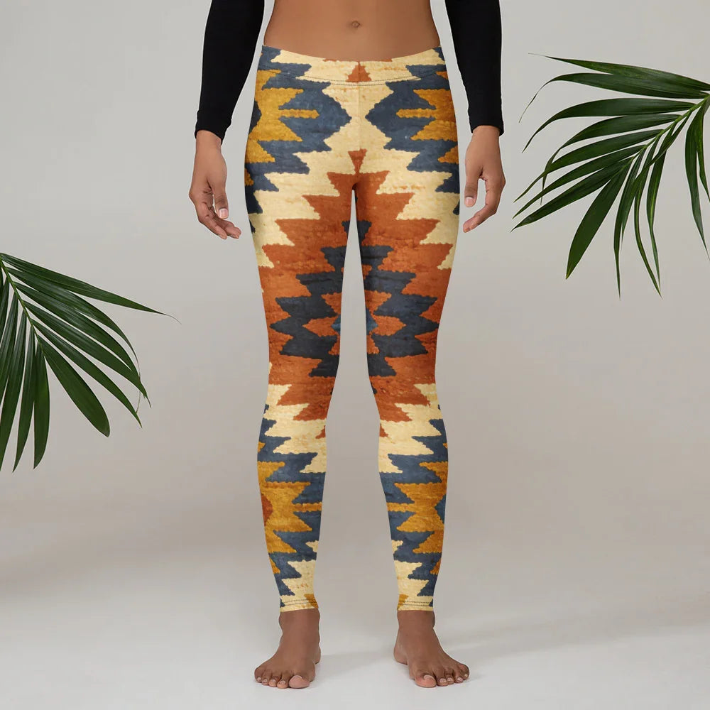 Colorful geometric print leggings by Mad Lad Designs with rust, gold, and blue zigzag pattern