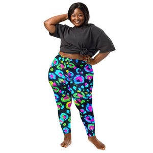 Plus size woman wearing bright psychedelic neon leopard print leggings and black knotted t-shirt standing barefoot