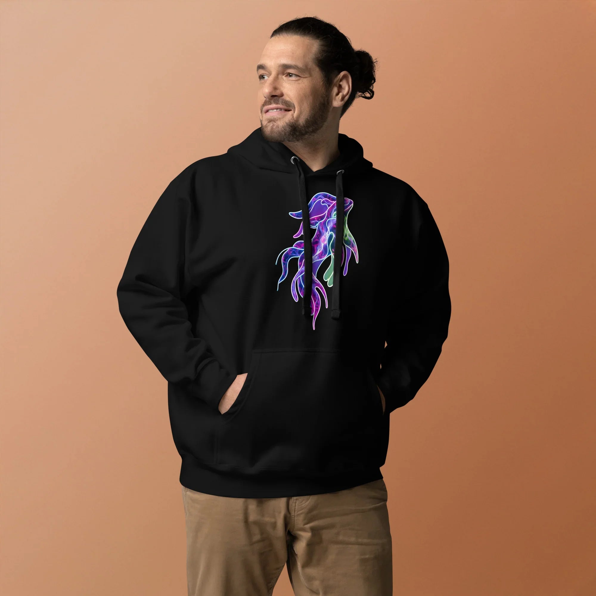 Man wearing black premium pullover hoodie with colorful psychedelic octopus design, neutral brown background