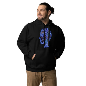 man wearing black unisex hoodie with neon blue psychedelic face design, brown pants, hands in pockets