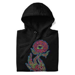Black unisex premium pullover hoodie with vibrant psychedelic neon hand holding a flower with an eye design