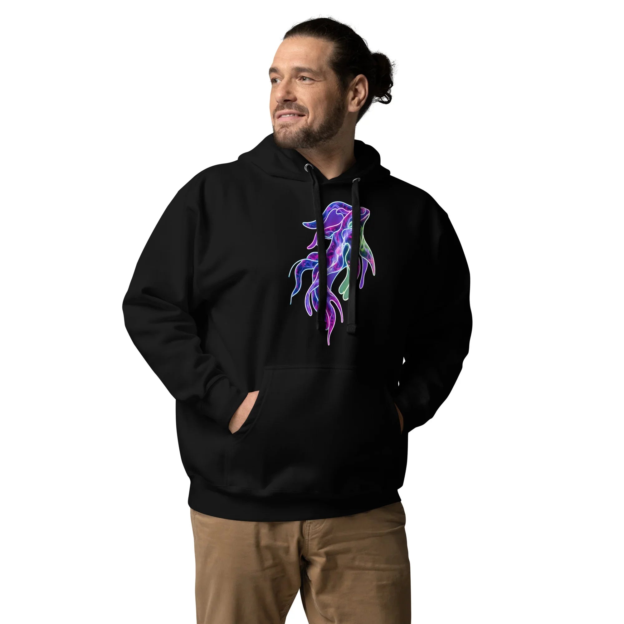 Man wearing black unisex pullover hoodie with vibrant psychedelic neon squid design, hands in pockets