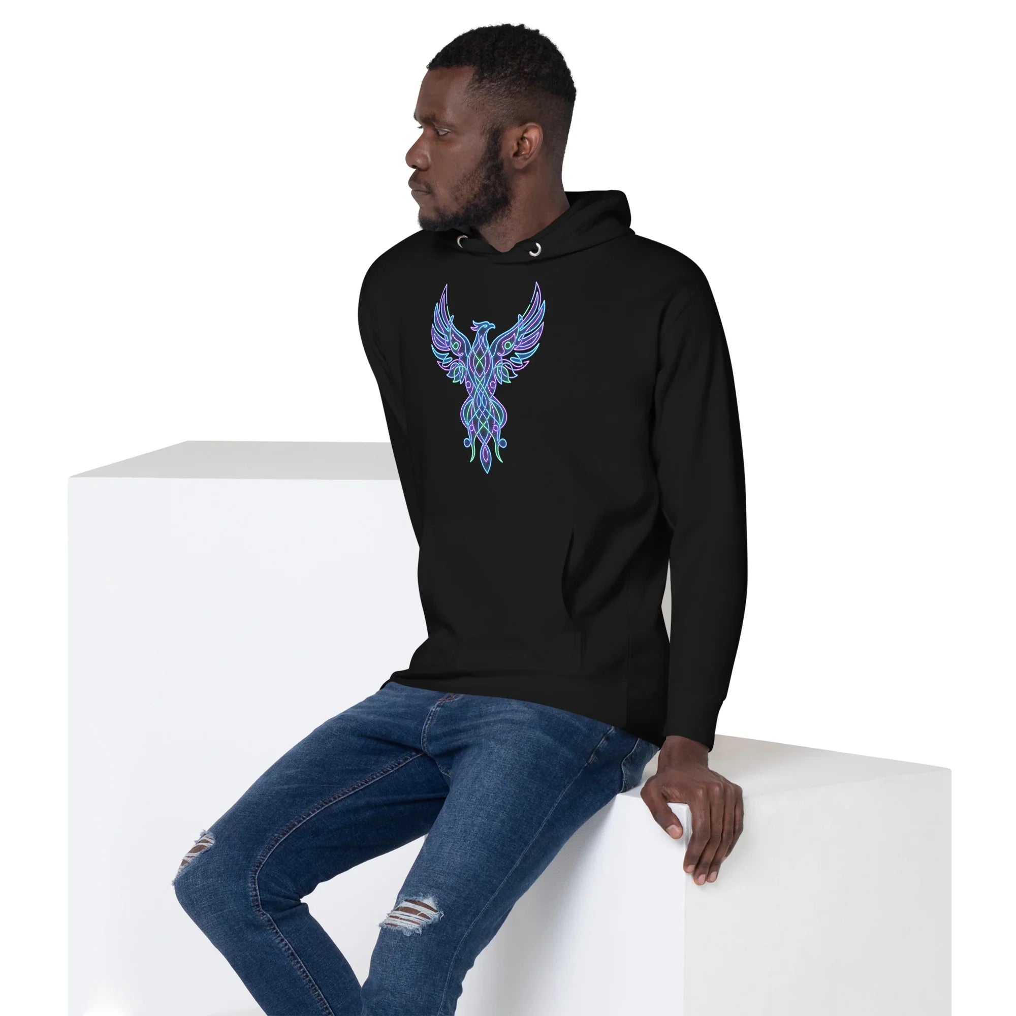 Man wearing black unisex premium pullover hoodie with neon blue and purple phoenix design, paired with ripped jeans