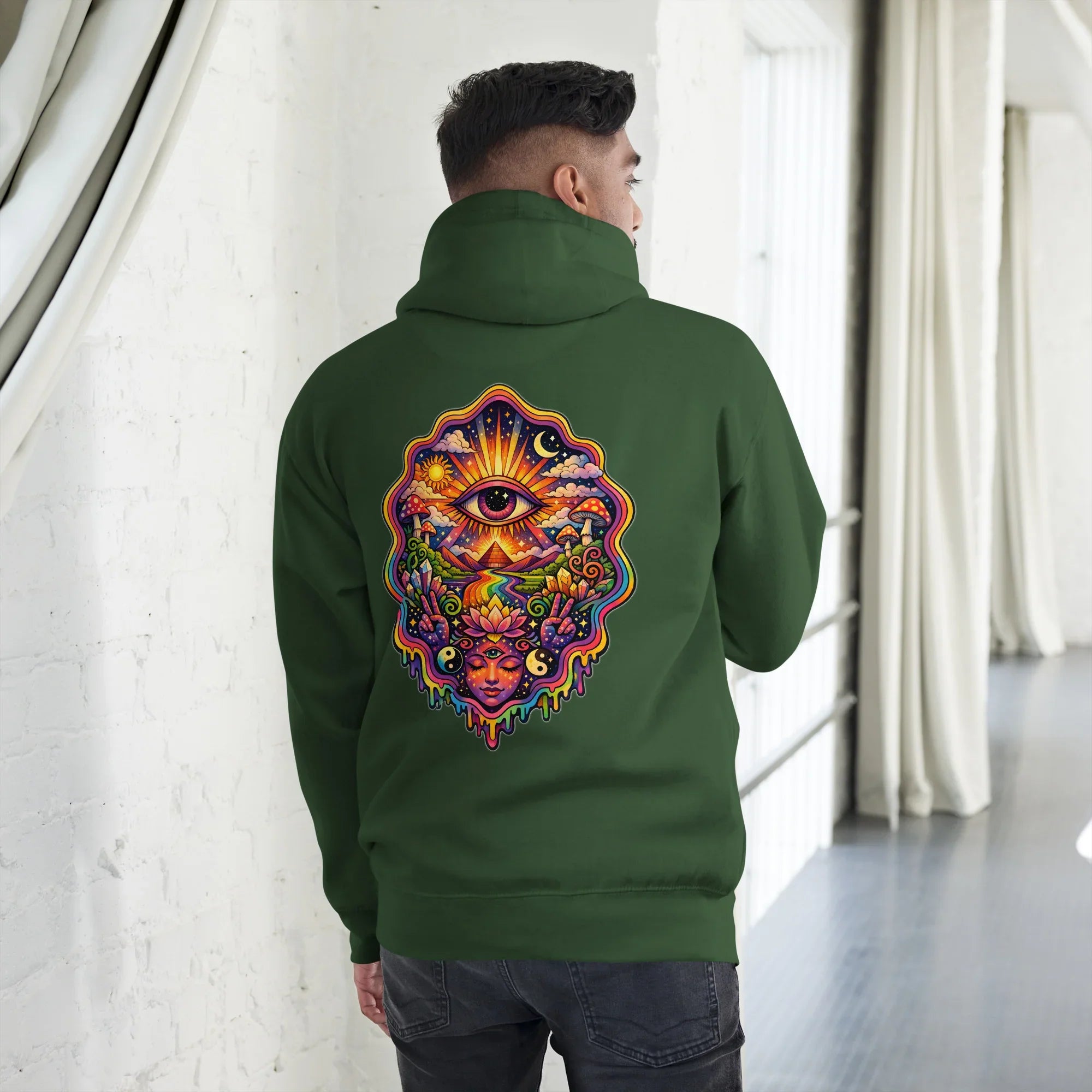 Man wearing forest green unisex premium pullover hoodie with vibrant psychedelic eye and nature design on back