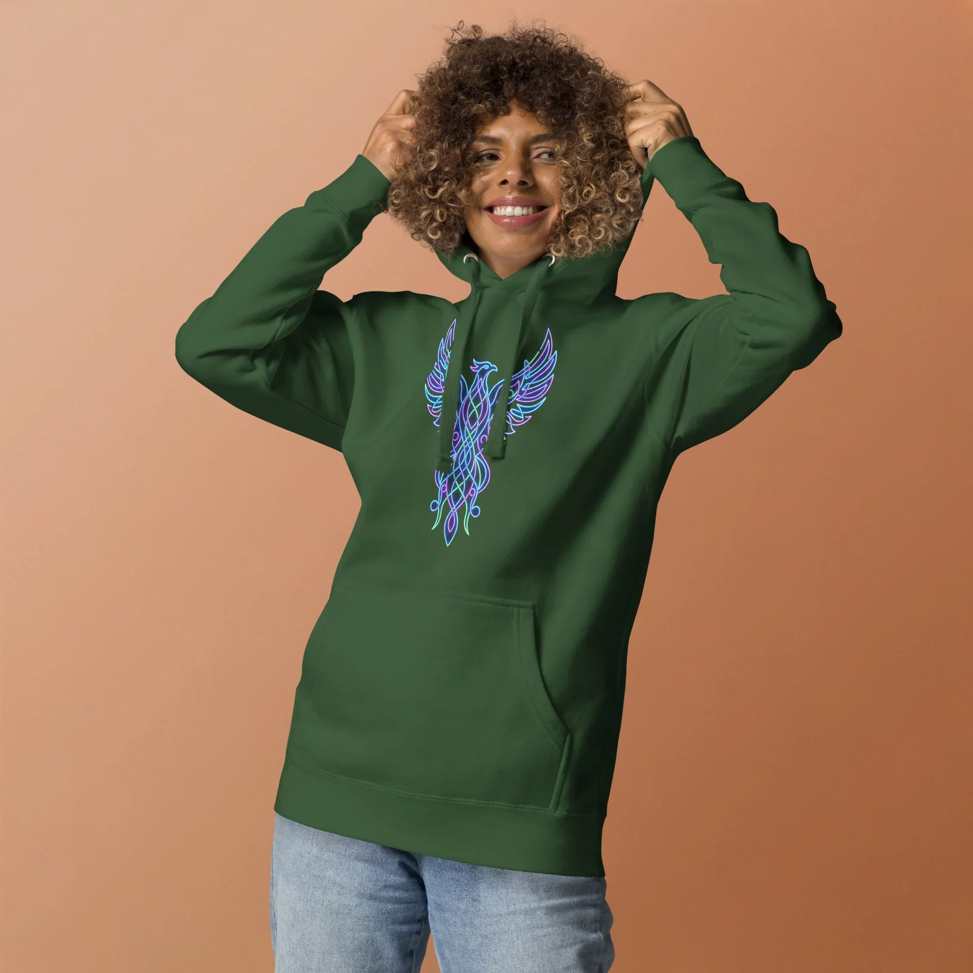 Smiling woman wearing forest green premium pullover hoodie with neon blue phoenix design on front