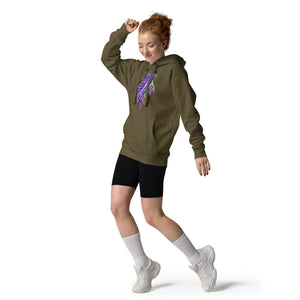 Red-haired woman dancing in military green unisex premium pullover hoodie with neon feather design, black shorts, white socks, and sneakers