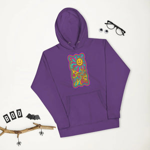 Purple unisex premium pullover hoodie with colorful psychedelic sun and mushroom art design, styled with glasses and Halloween decor