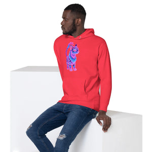 Man wearing red unisex pullover hoodie with neon tribal cat graphic and ripped blue jeans sitting on white block