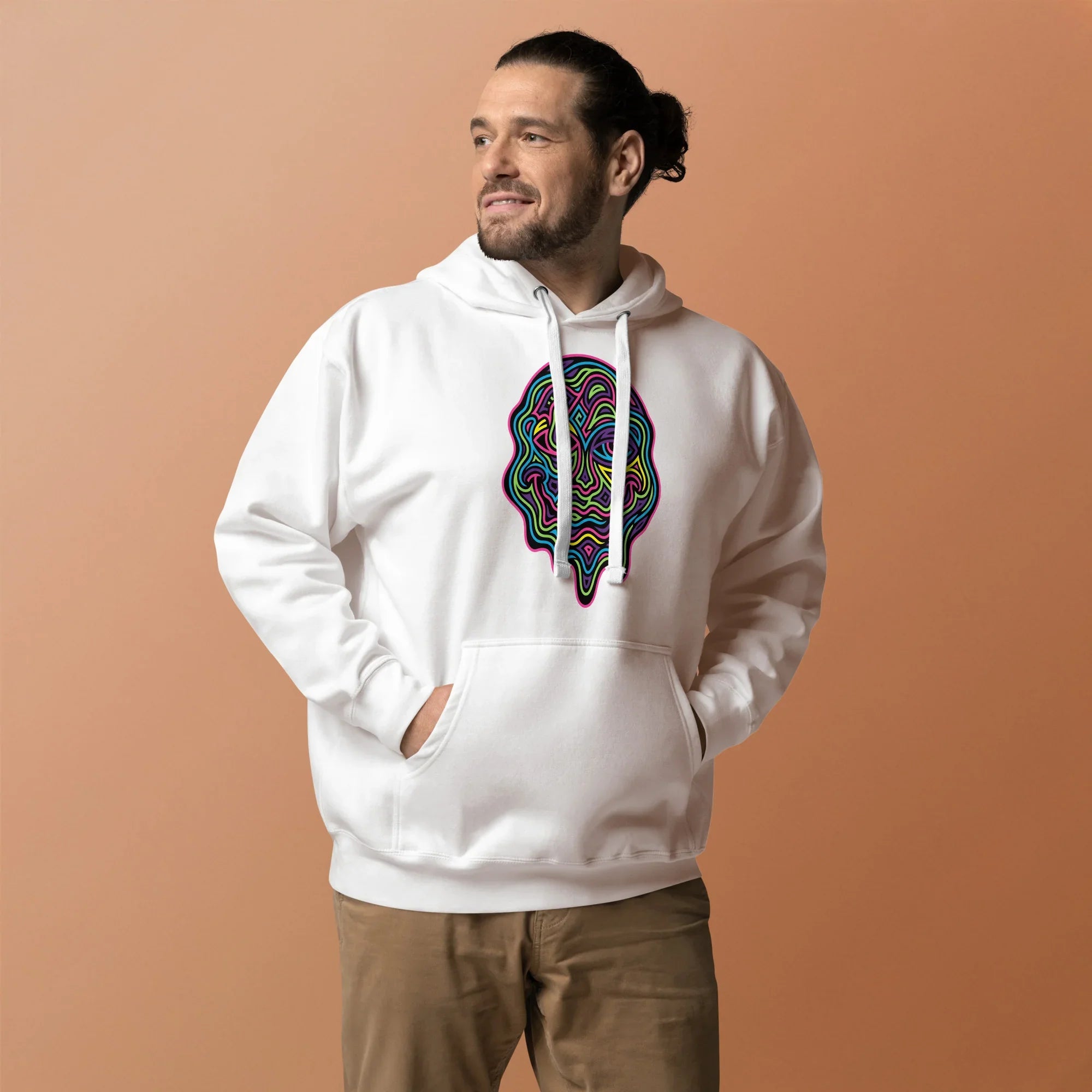 Man wearing white pullover hoodie with psychedelic multicolor melting face design, beige pants, and light brown background