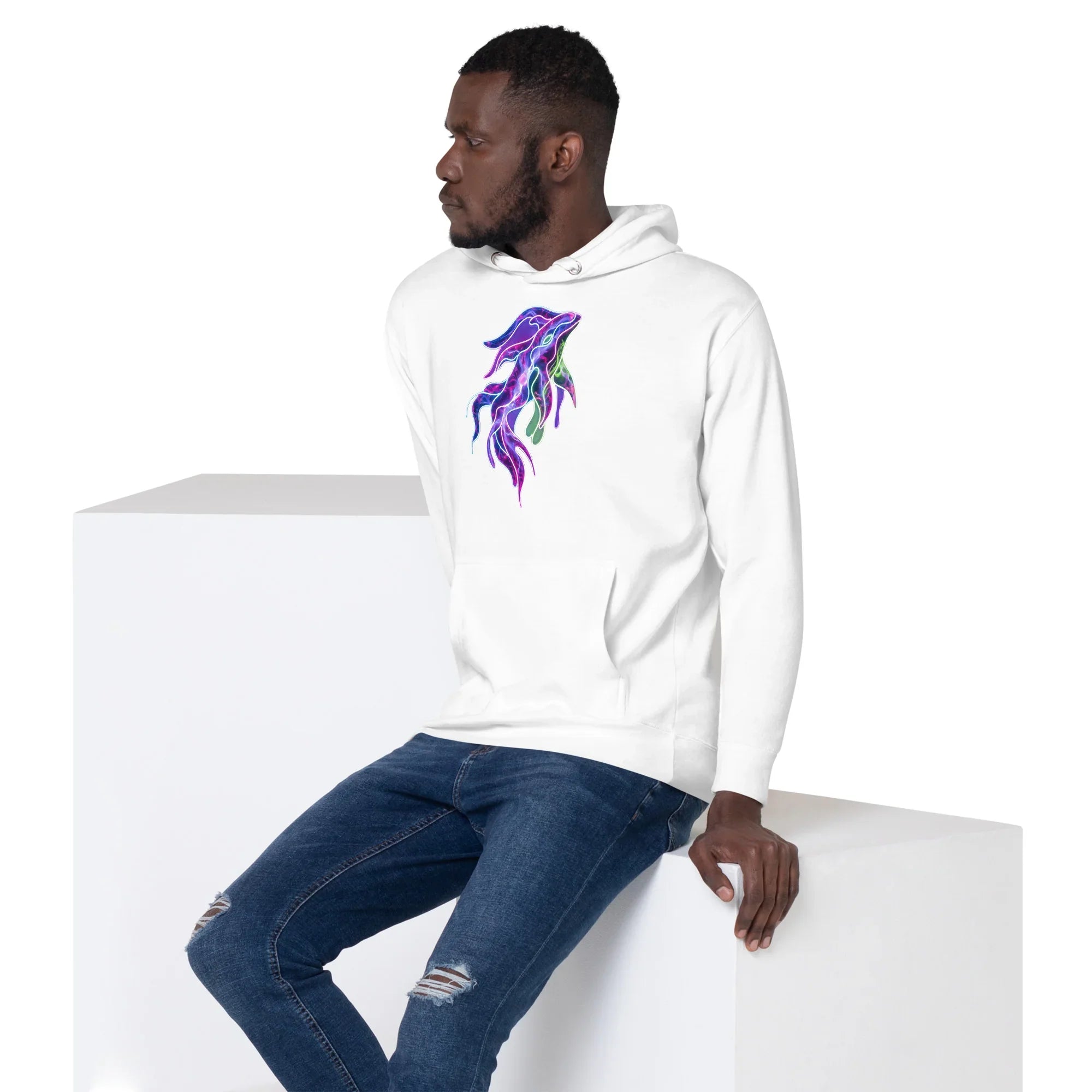 Man wearing white premium pullover hoodie with colorful psychedelic squid design sitting on white block