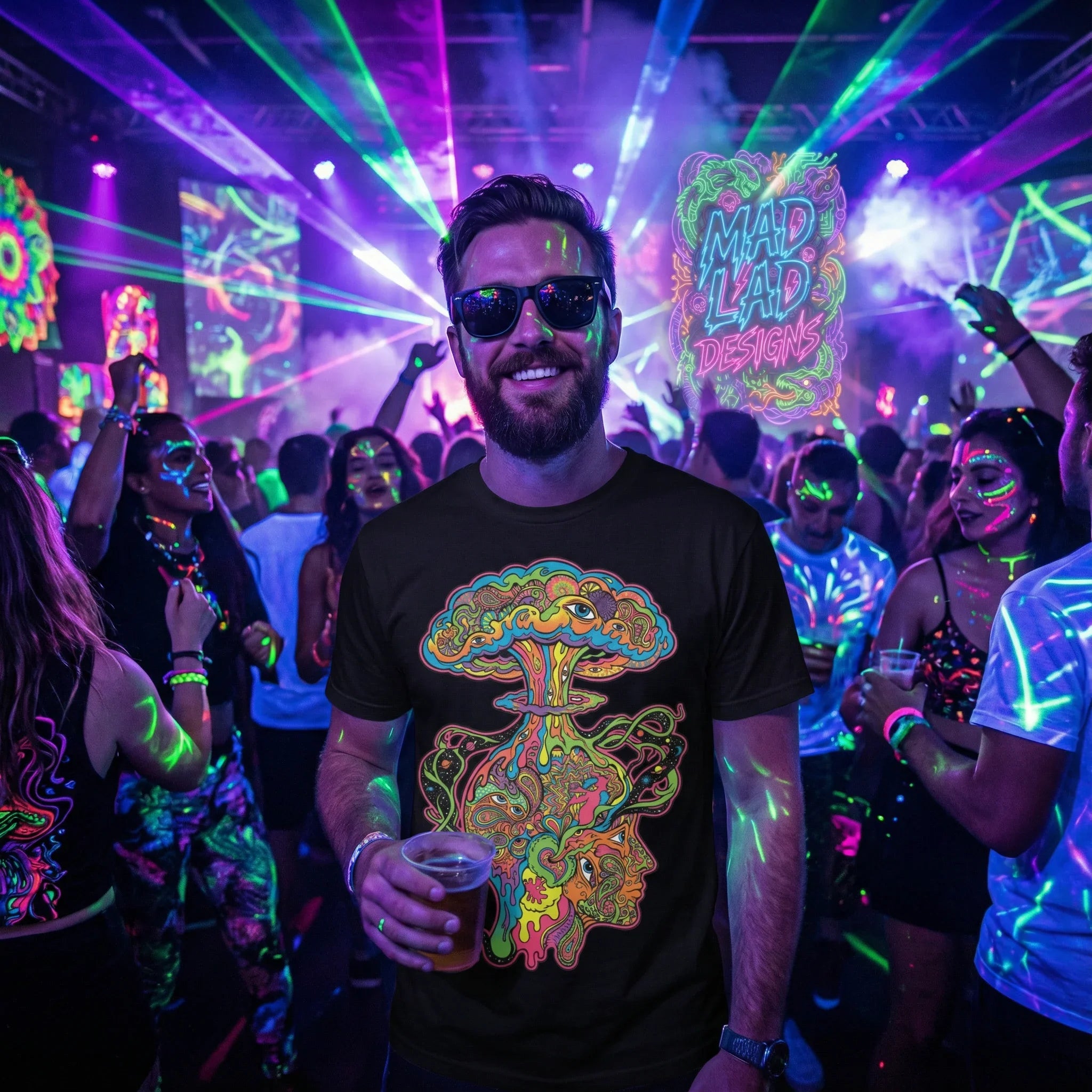 Man wearing black neon psychedelic art t-shirt at vibrant party with UV lights and crowd