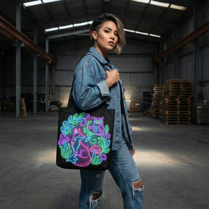 Woman in denim outfit carrying a black tote bag with neon psychedelic fox and owl design