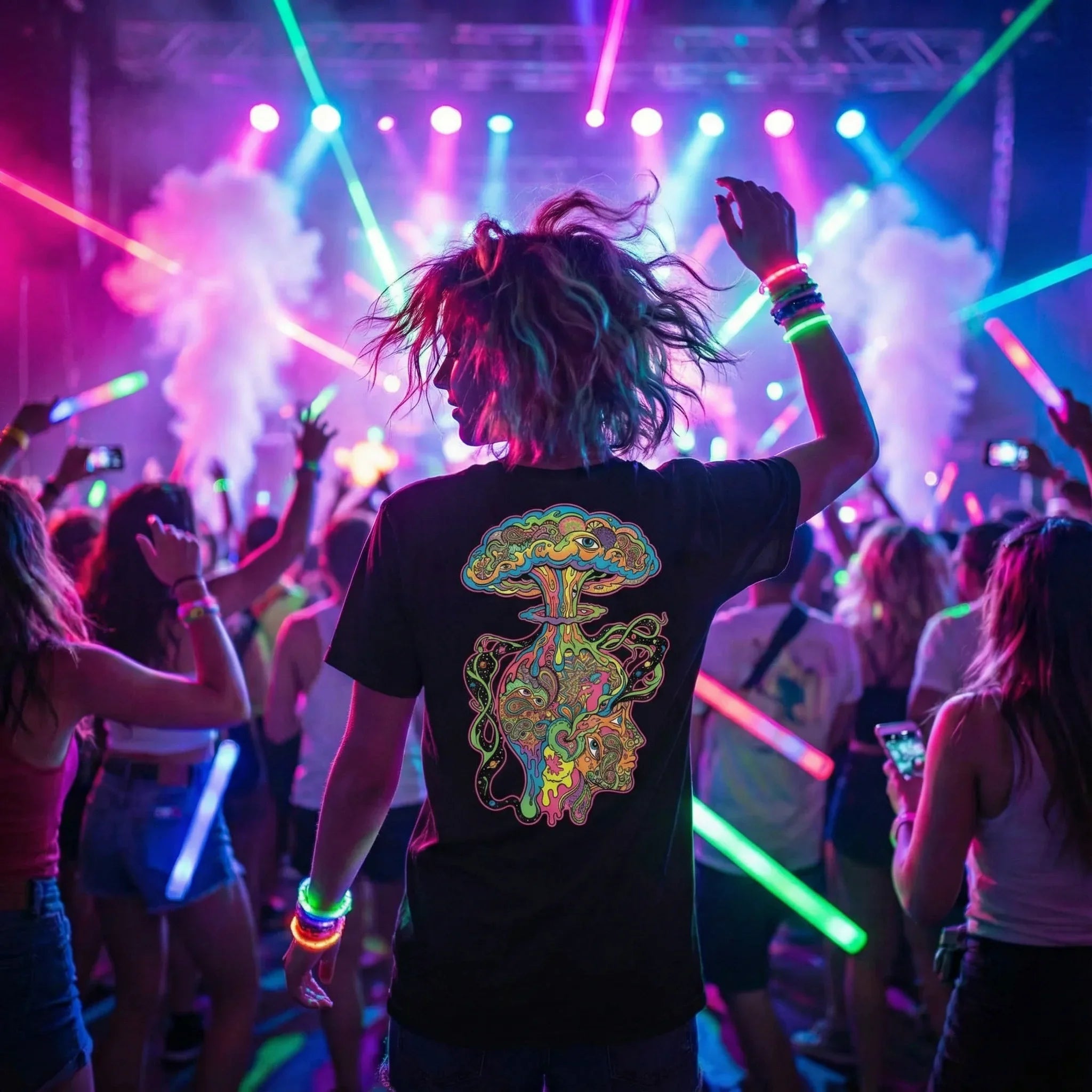 Person wearing psychedelic t-shirt with colorful design at vibrant neon-lit music festival crowd