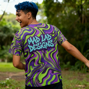 Person wearing vibrant Mad Lad Designs psychedelic neon shirt outdoors, smiling