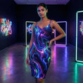 Woman in a vibrant galaxy-pattern dress posing in a neon-lit modern art gallery