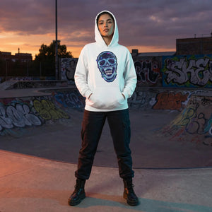 Woman in white psychedelic skull hoodie poses at graffiti skatepark at sunset, Mad Lad Designs