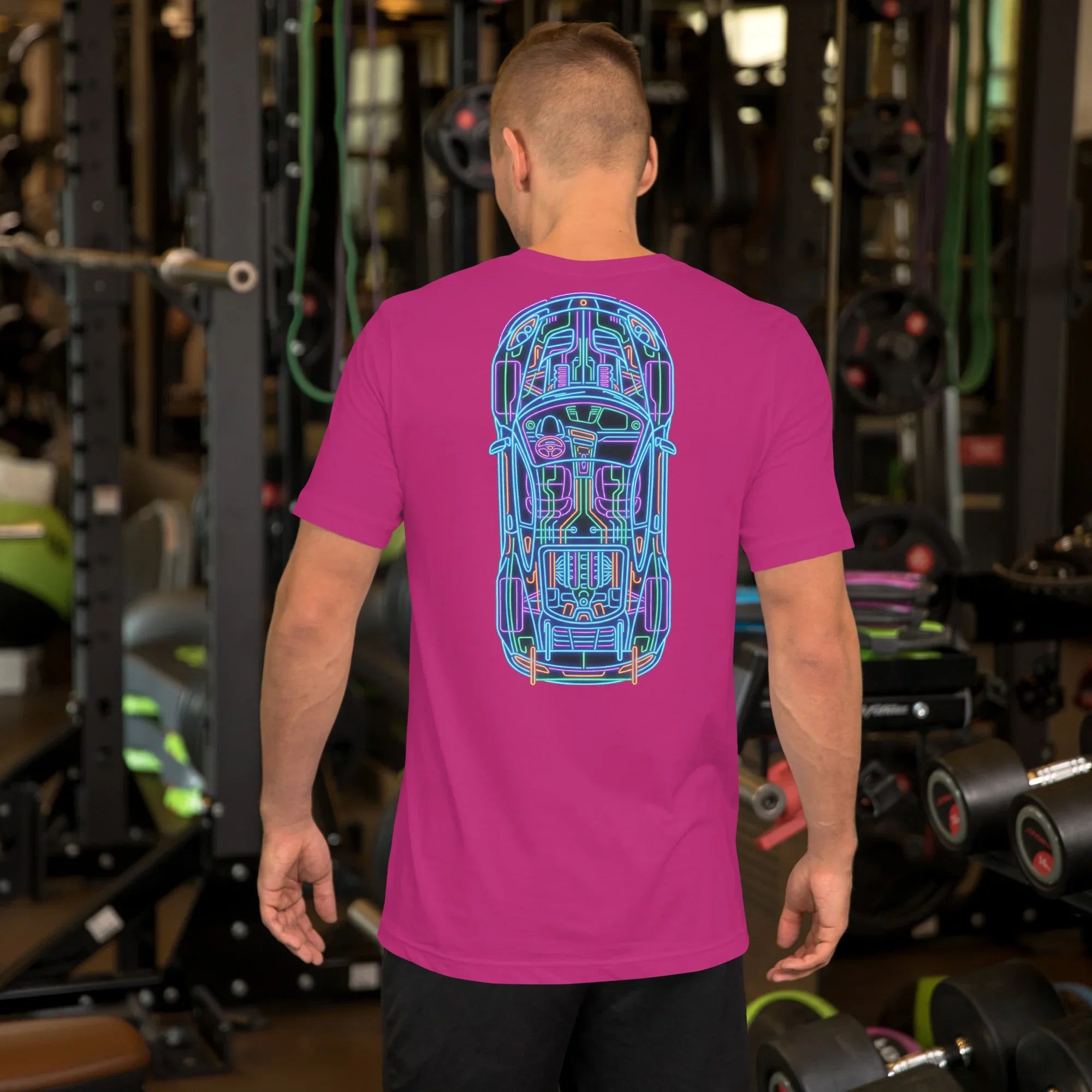 Man wearing berry unisex t-shirt with neon car blueprint design on the back in gym setting