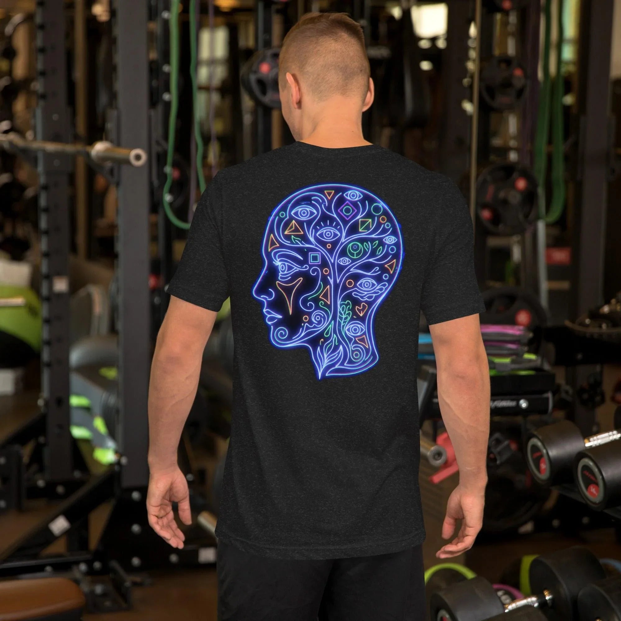 Man wearing black heather t-shirt with neon blue psychedelic face and eye design in gym setting