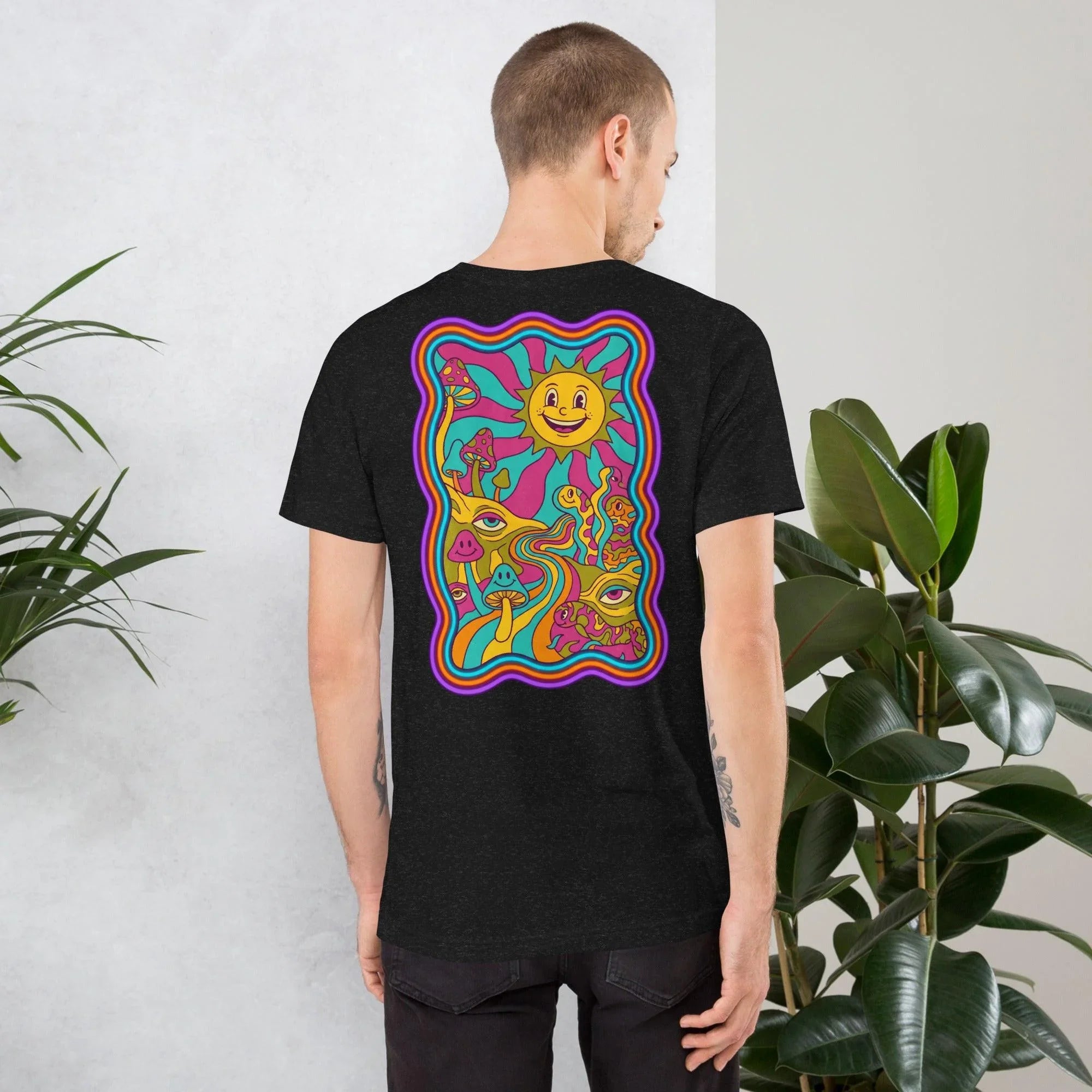 Man wearing black heather unisex t-shirt with colorful psychedelic sun and mushroom art design on back