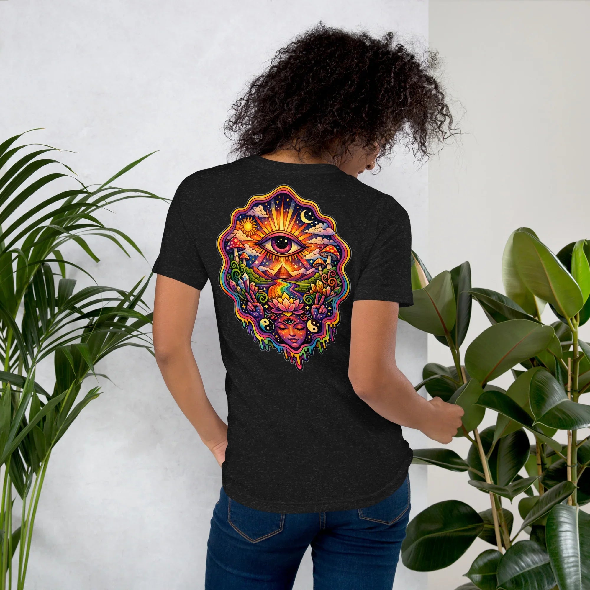 Woman wearing black heather unisex staple t-shirt with vibrant psychedelic eye and nature design on back