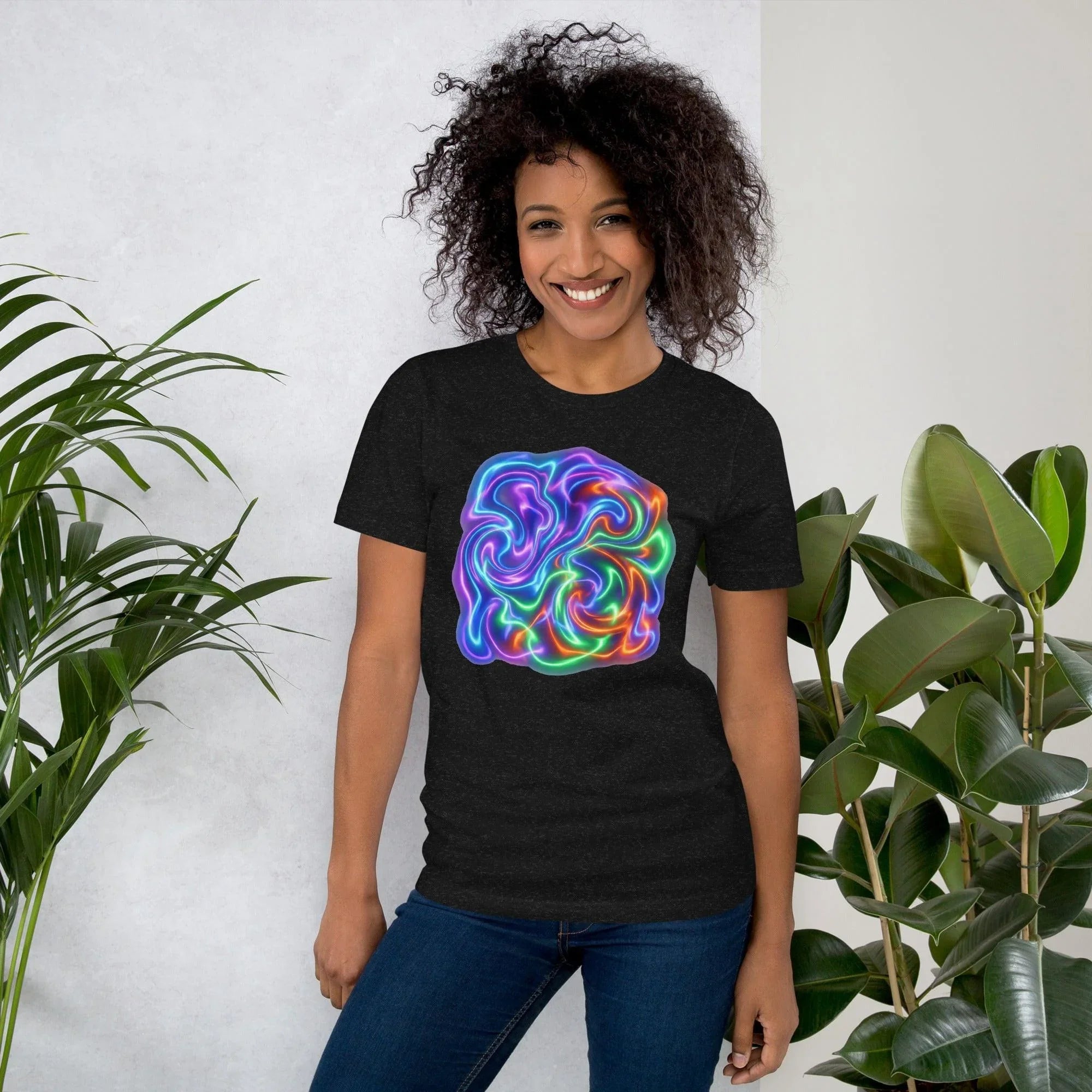 Smiling woman wearing black unisex staple t-shirt with vibrant psychedelic neon swirl design, indoor with plants