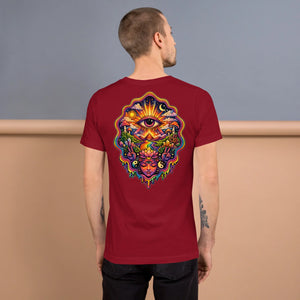 Man wearing cardinal red unisex t-shirt with vibrant psychedelic art on back featuring an all-seeing eye, sun, moon, mushrooms, lotus flower, and yin-yang symbols