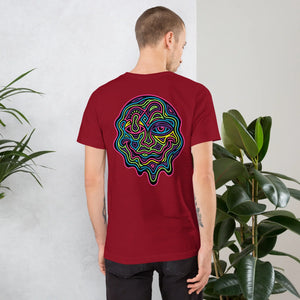 Man wearing cardinal red unisex t-shirt with vibrant neon psychedelic abstract face design on back, indoor plant background