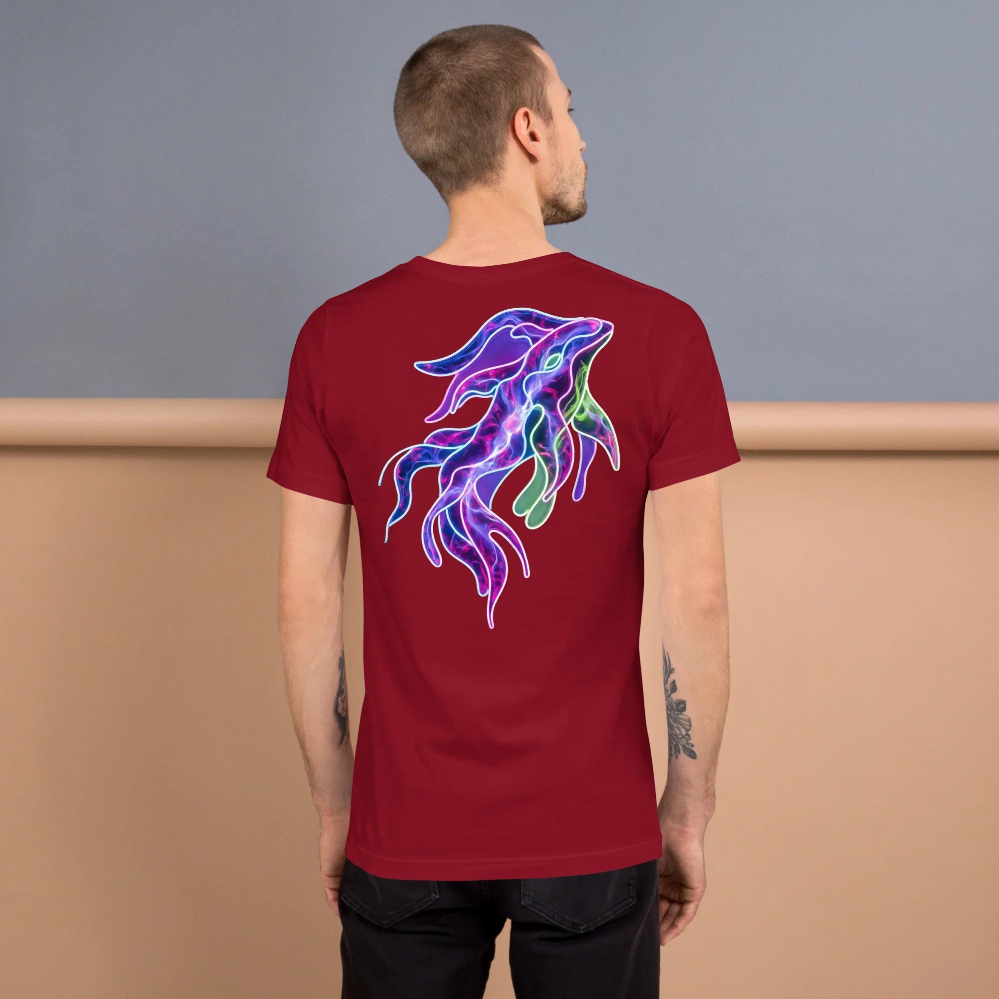 Man wearing cardinal red unisex t-shirt with neon psychedelic squid design on back
