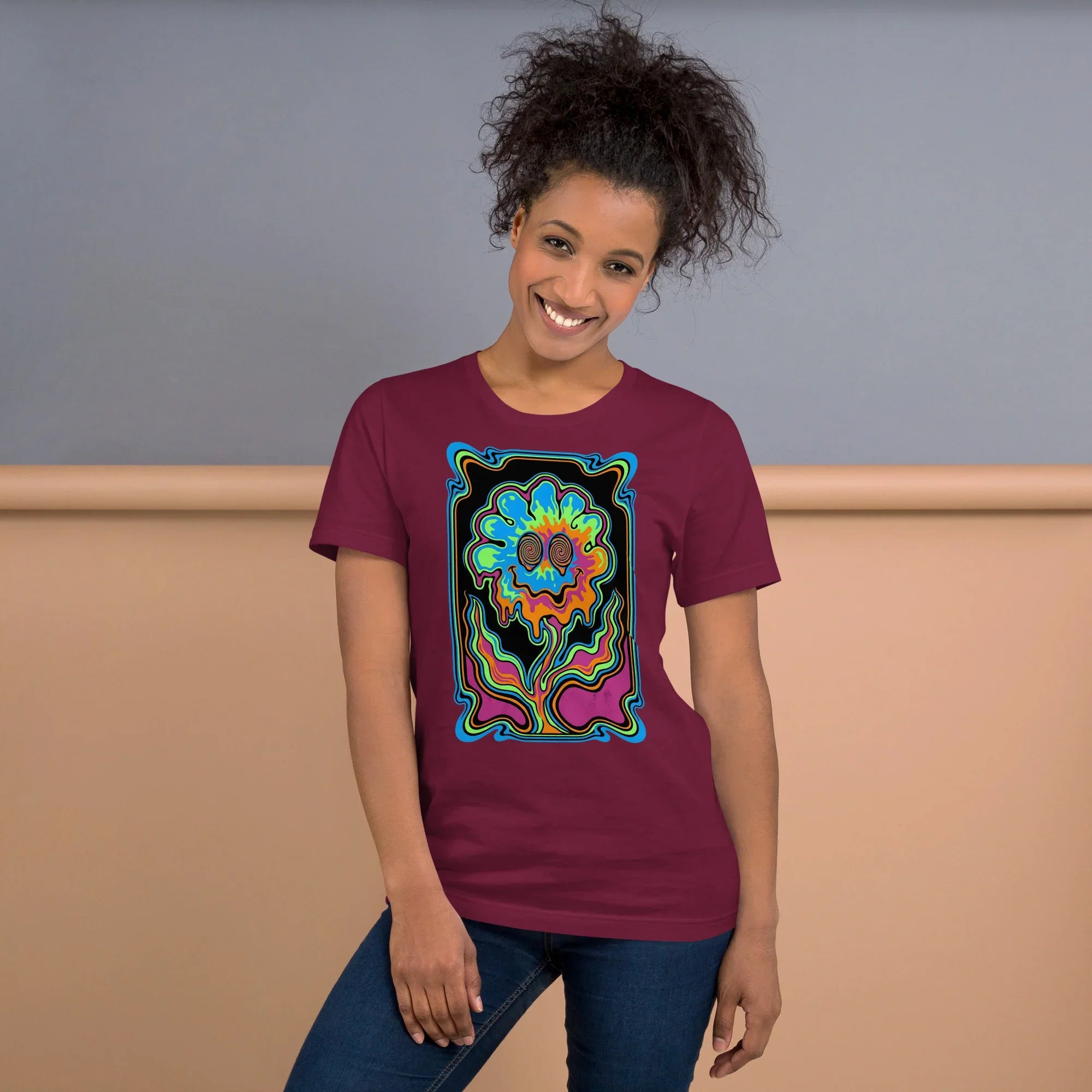 Smiling woman wearing maroon psychedelic graphic t-shirt with colorful abstract flower design