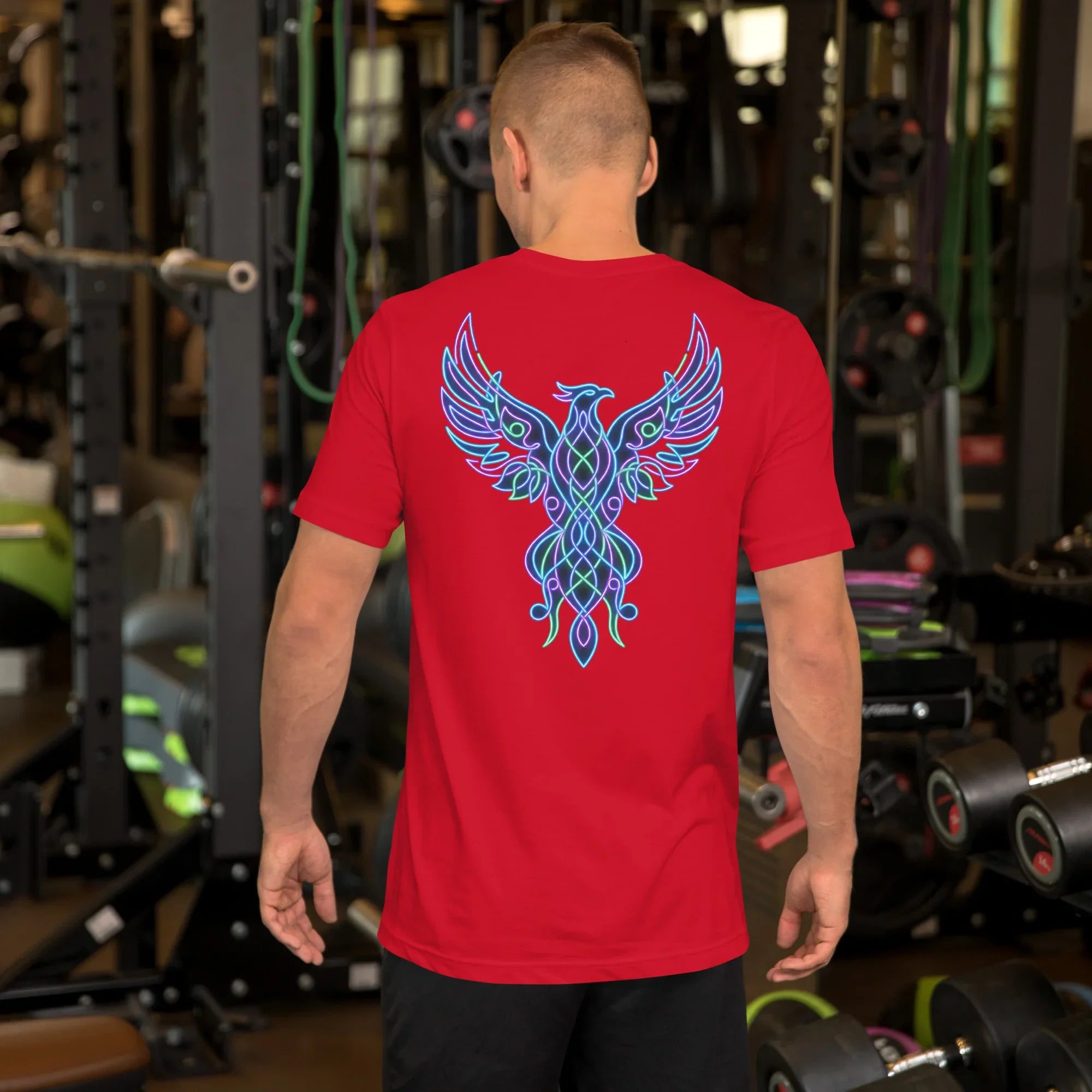 Man in gym wearing red unisex t-shirt with neon psychedelic phoenix design on back