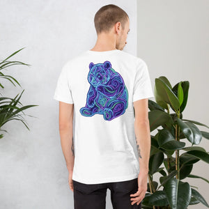 Man wearing white unisex T-shirt with vibrant neon psychedelic bear design on back in modern indoor setting