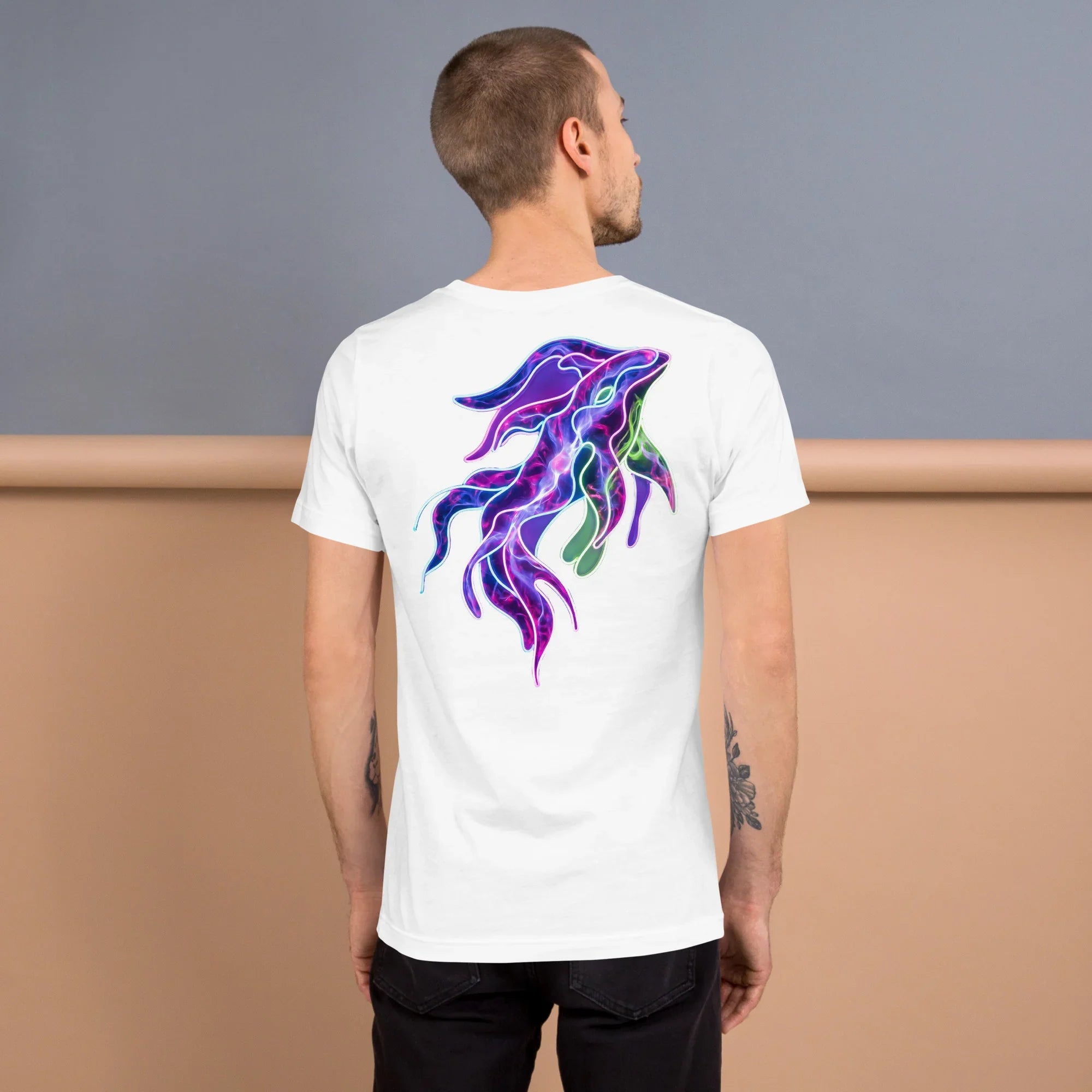 Man wearing white unisex t-shirt with vibrant psychedelic neon squid art on back, colorful streetwear